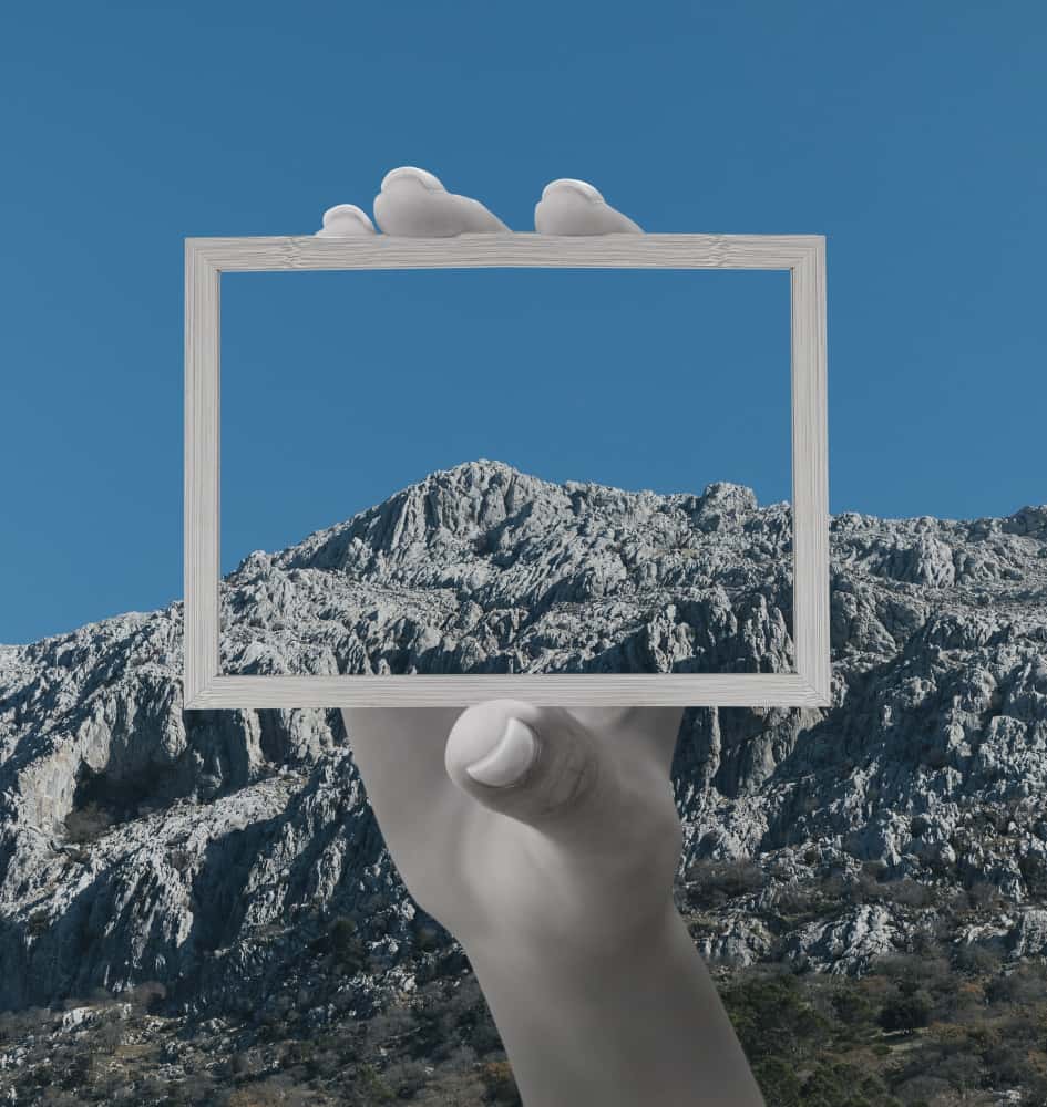 person hold frame with landscape